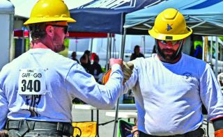 Lineworkers fist bump cover