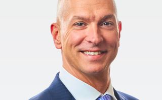 Photo of John Hewa, President & CEO of REC